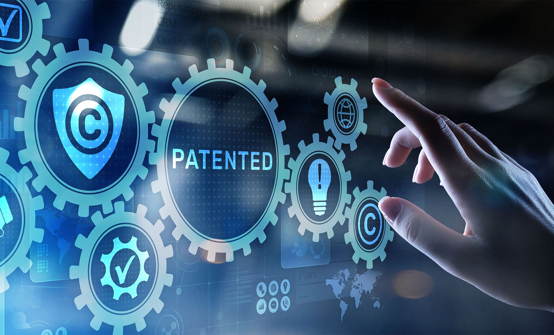 A hand interacts with digital gears displaying icons for patents, copyright, and ideas, representing intellectual property and innovation concepts.